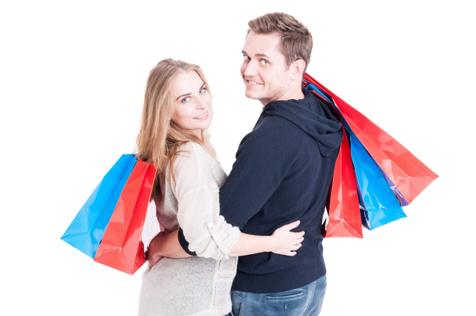 Attractive couple embracing and holding bunch of shopping bags and smiling isolated on white background with copy text space